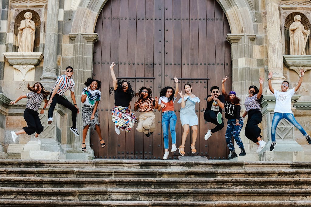 A group of people jumping in the air on church steps