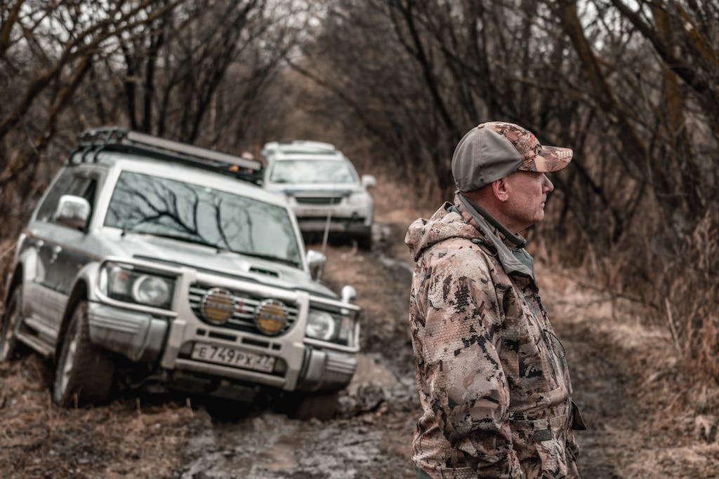 Man Off-road with His Car Stuck in Mud