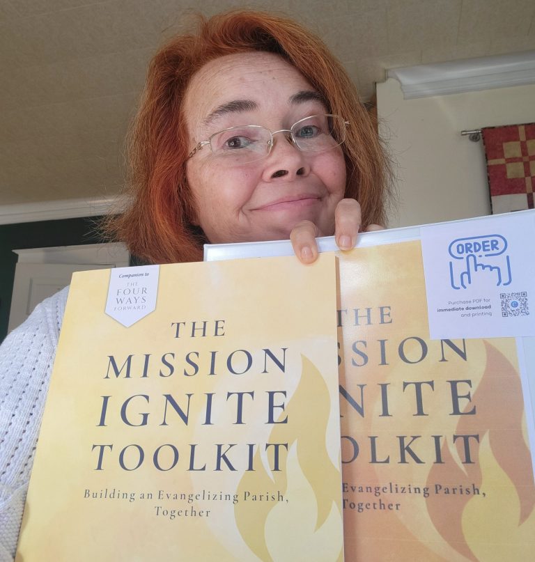 Susan Windley-Daoust holding The Mission Ignite Toolkit (paperback and PDF versions)